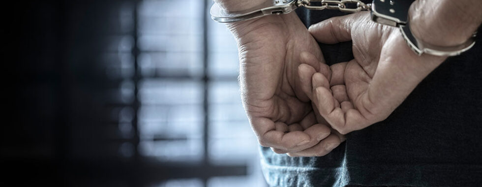 Man arrested in handcuffs